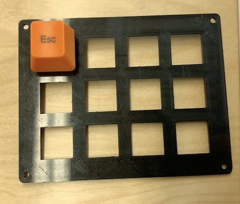 3D-printed mount with a single switch and keycap inserted.